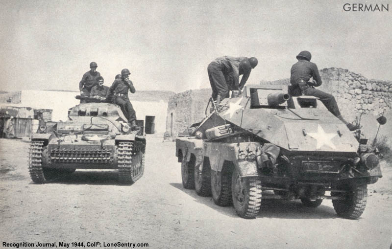 [Captured German Panzer II tank and 8-wheeled armored car]